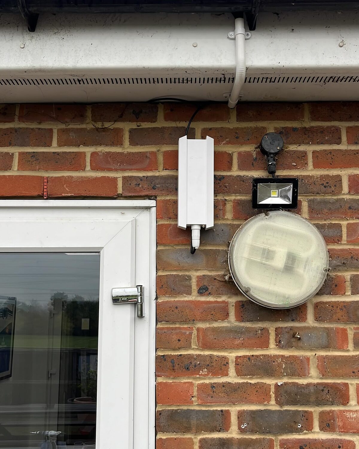 Weatherproof outdoor WiFi access point mounted on the brick wall at Istead Rise Community Centre